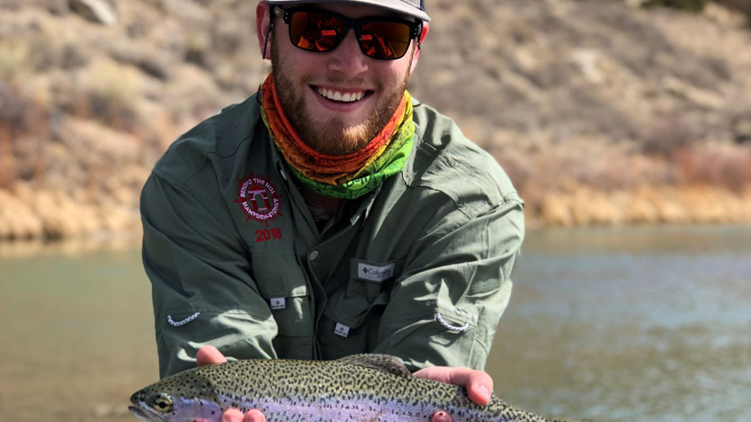 Hampden-Sydney student and leader holding a fish