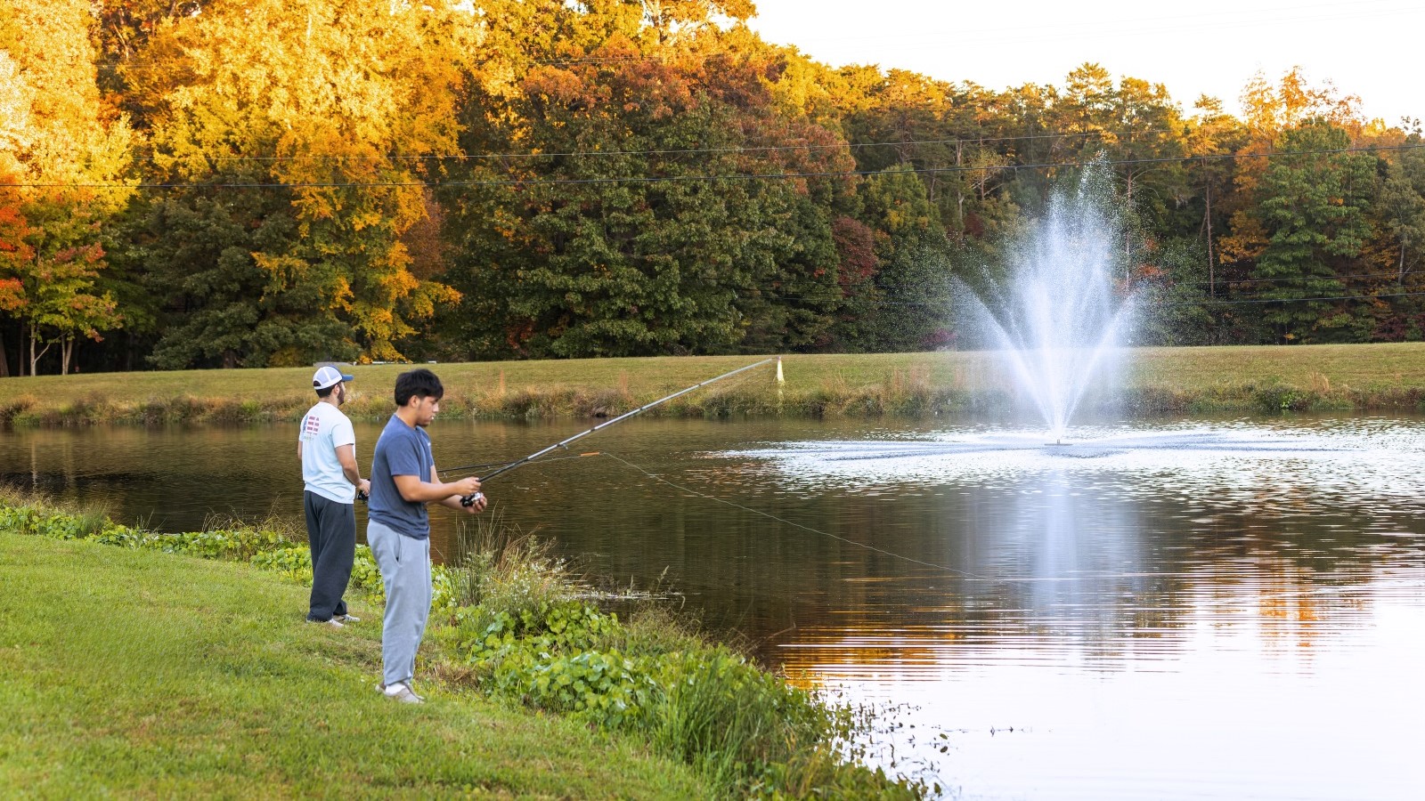 Students fishing Lake Chalgrove at Hampden-Sydney College's high ropes course