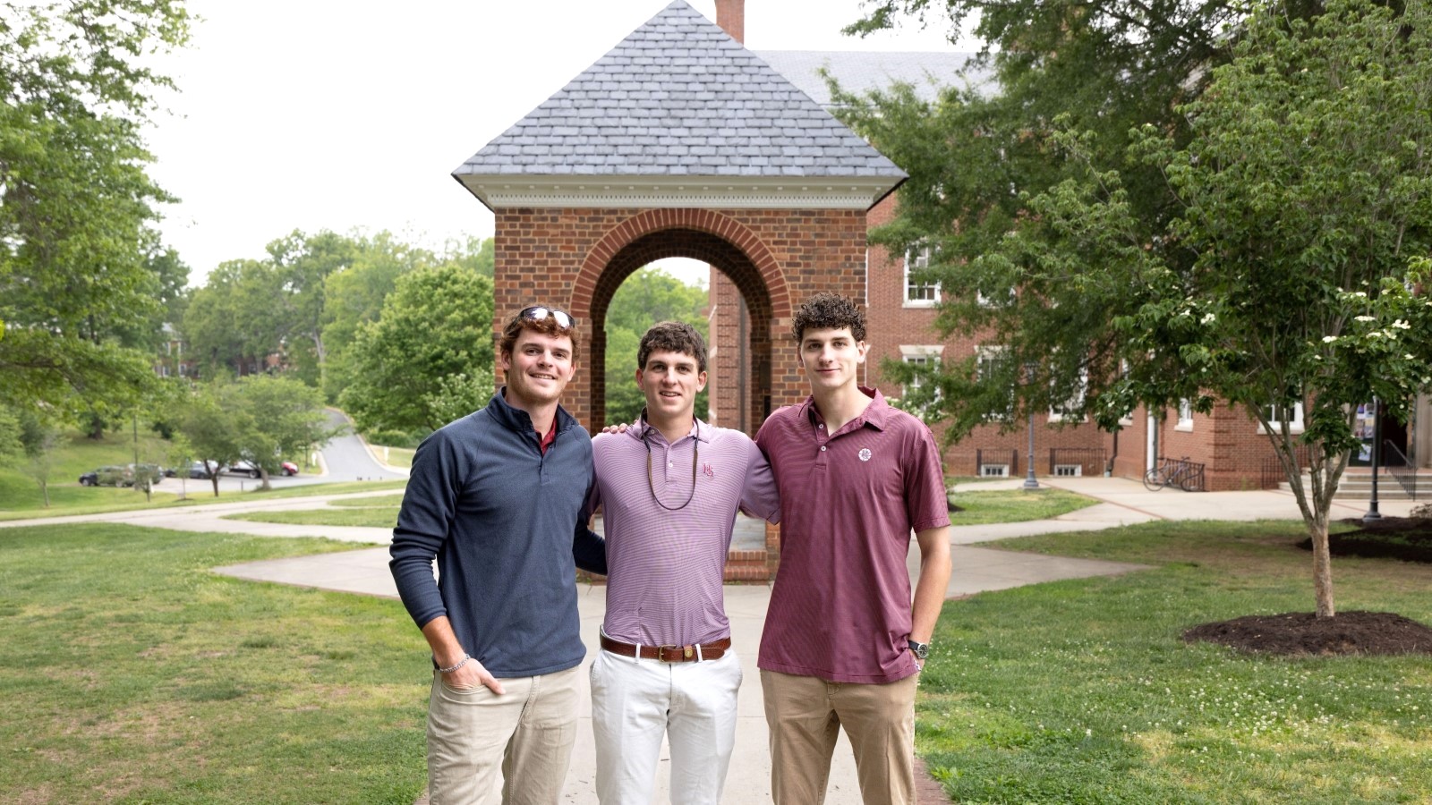 The three Messinger brothers standing in front of the Bell Tower