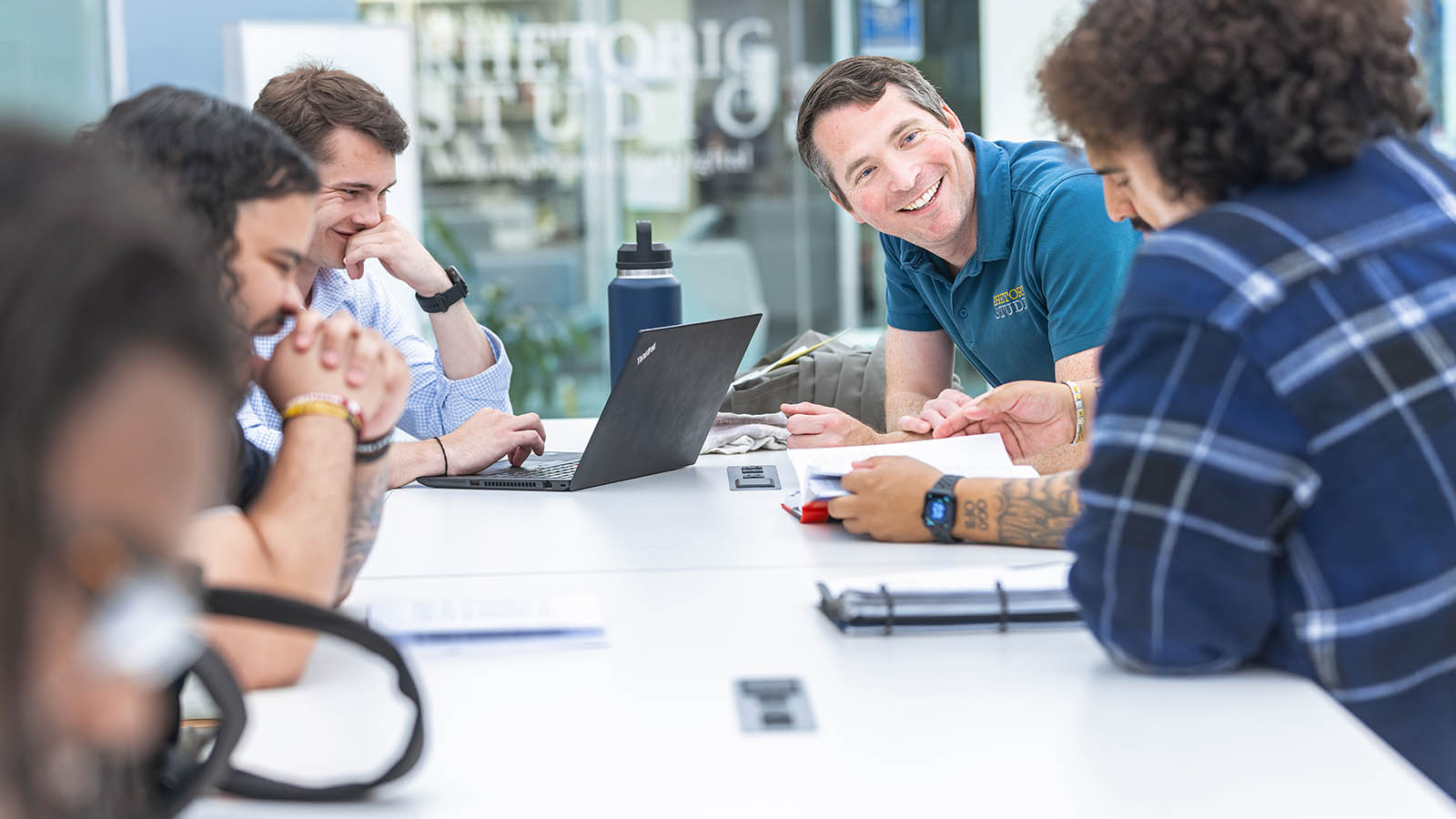 Hampden-Sydney professor and students working at a table together in the rhetoric center