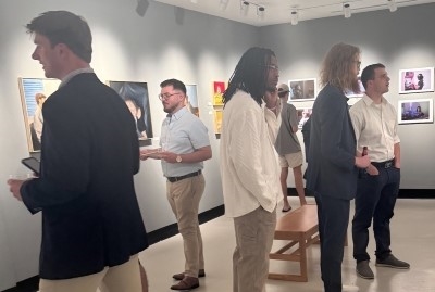 gallery filled with students observing framed images