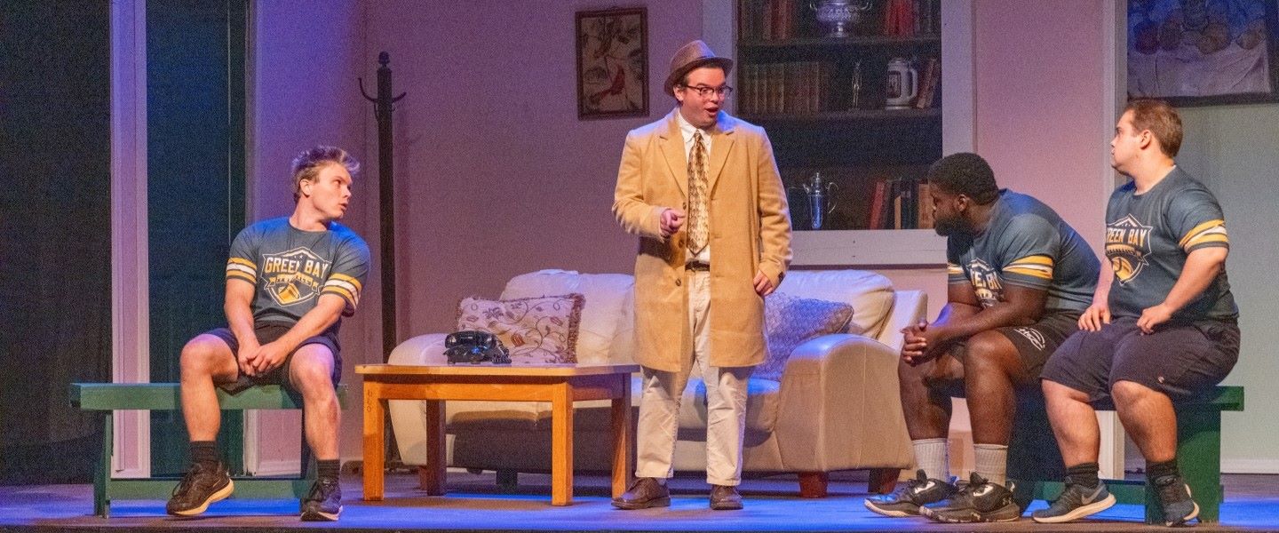 Students performing on stage in a theatre performance