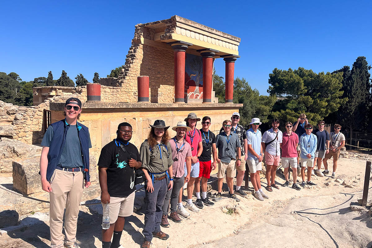 students gathered at the site of ancient ruins in Greece