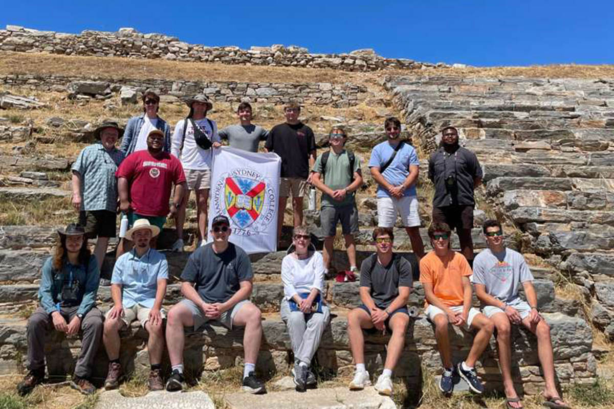 students gathered at the site of ancient colosseum in Greece