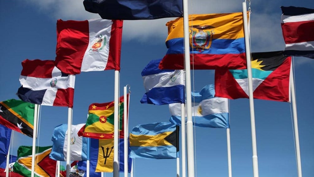 Latin American flags waving in the sky