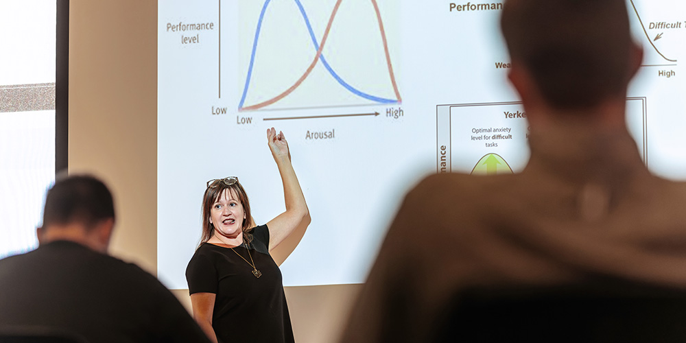 professor presenting research on a projector