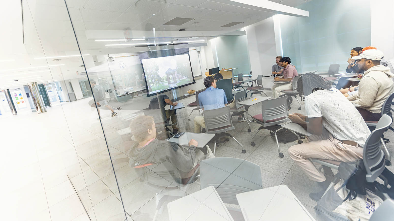 a view of a classroom and students through a glass wall