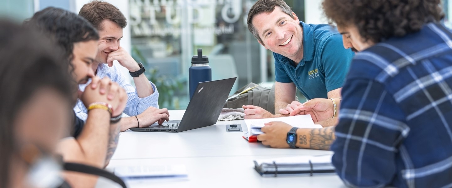 students and professors collaborating at a table