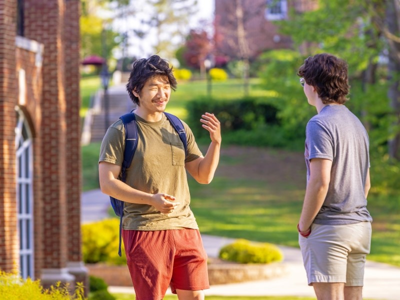 Two students talking in front of Pannill Hall