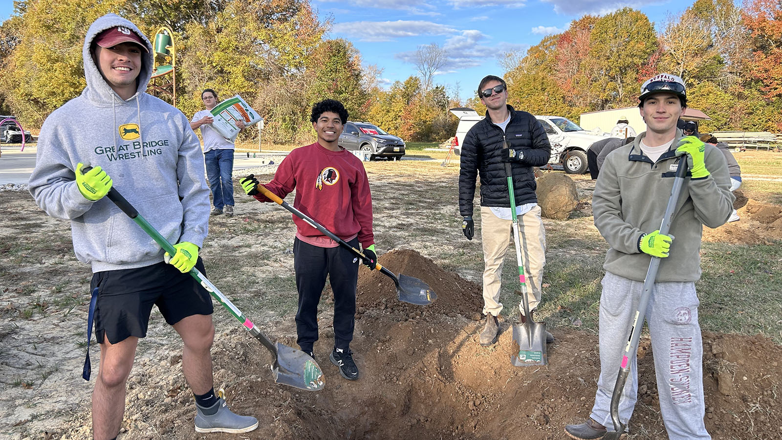 students digging holes to plant trees