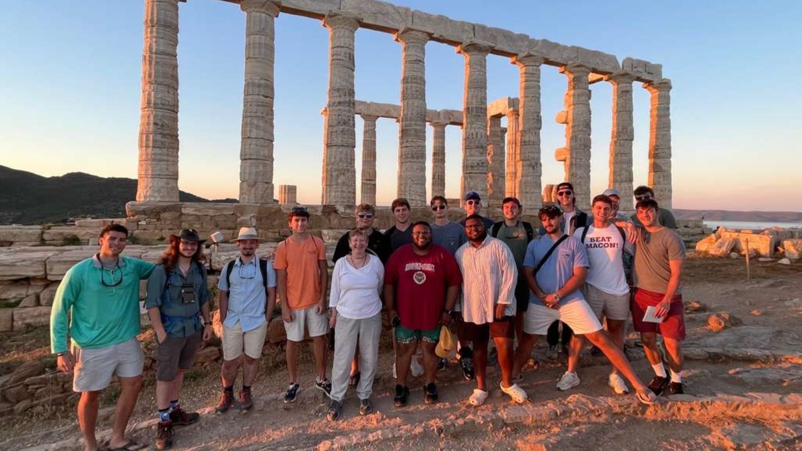 students gathered at the site of ancient ruins in Greece