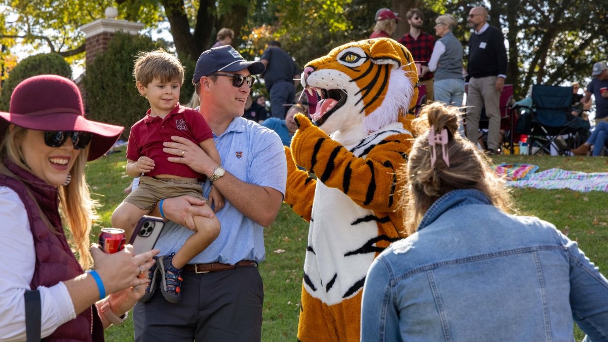 alumni family witrh the Hampden-Sydney Tiger at a football game