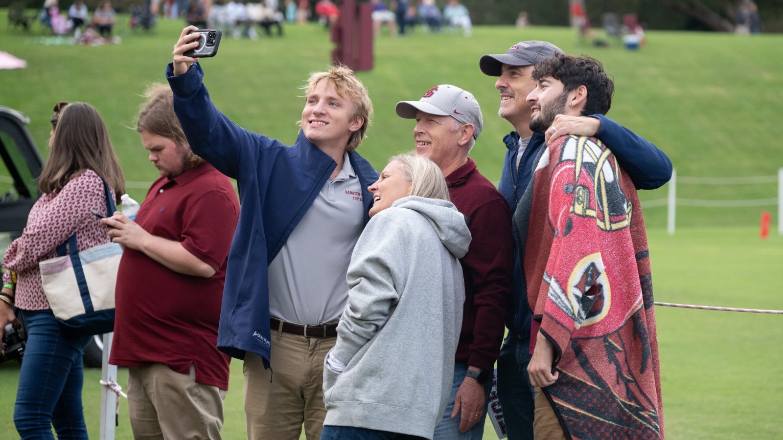 a family posing for a selfie on the football field