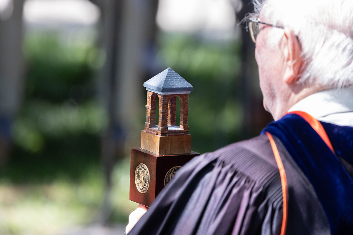 Faculty professor in regalia leading the priocession