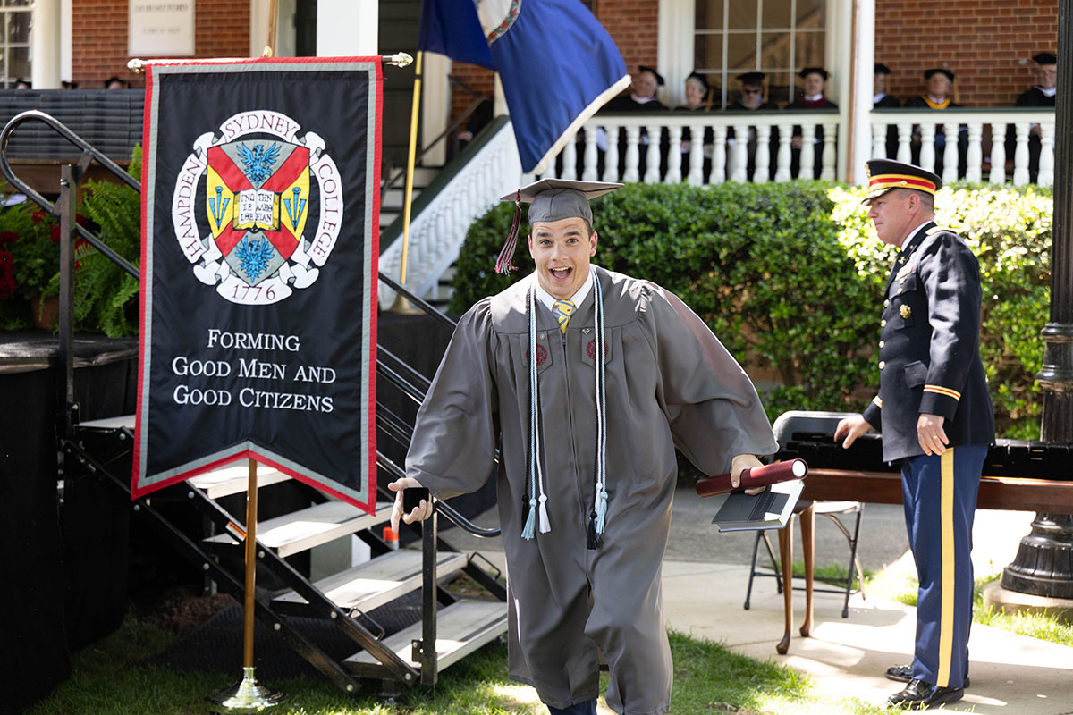 Class of 2025 student walking away with his diploma