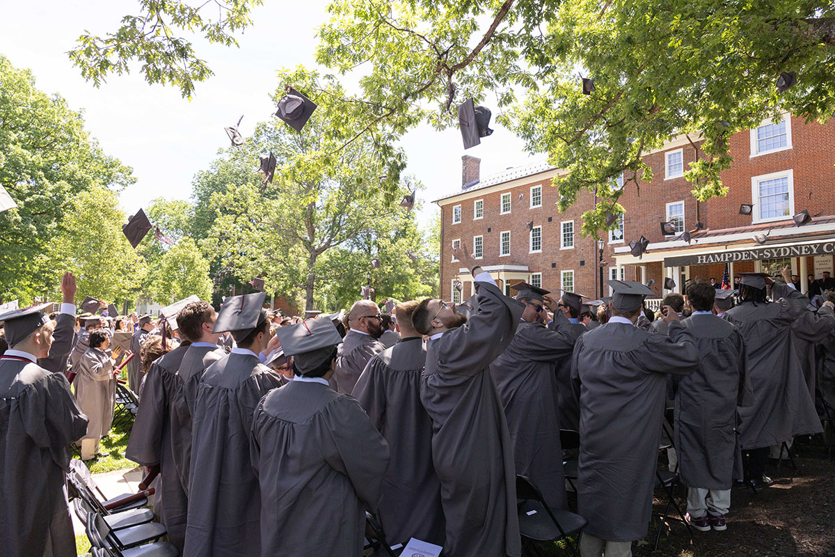 Class of 2025 students tossing their caps