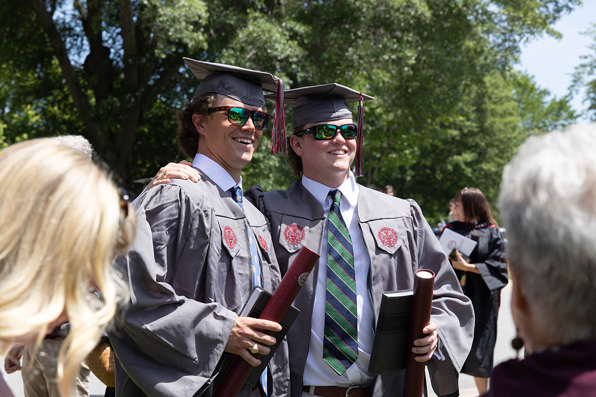 Class of 2025 students toasting champagne and smiling for a photo