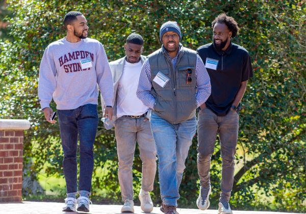 Men of color walking together on a sidewalk on campus