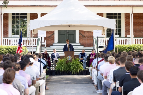 student leader speaking to a crowd of students at opening convocation ceremony