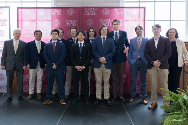a group of students and administration posing at the ceremony