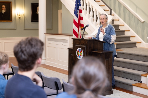 Dr. Leni Sorenson standing at a podium giving a lecture to the Hampden-Sydney community.