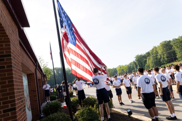 Boys State participants raising the American flag
