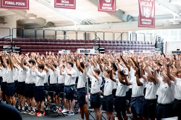 Boys State participants clapping at a group event