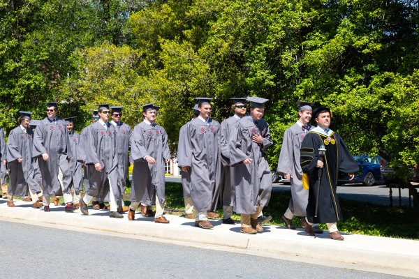 graduates in regalia processing to convocation