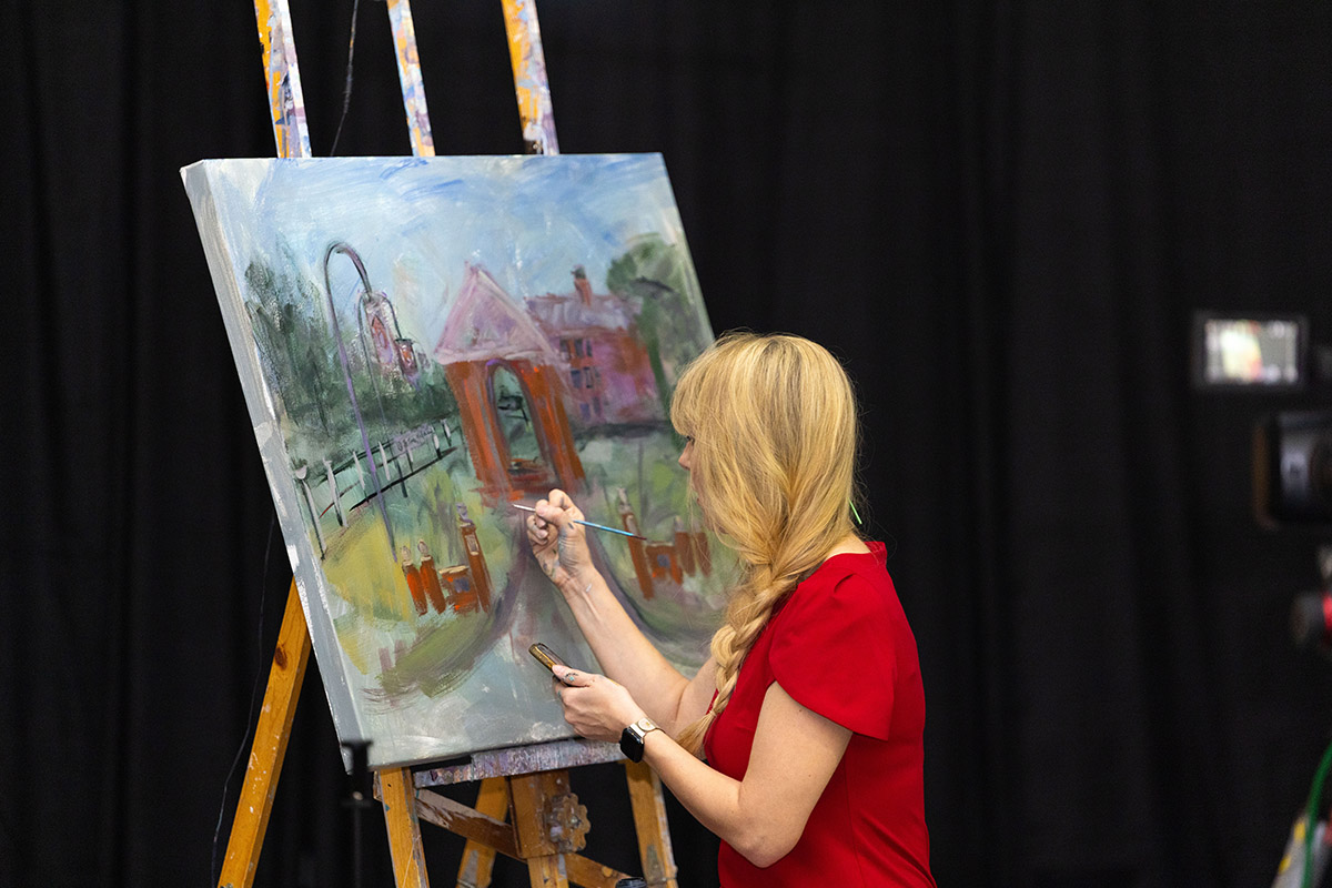 An artist creating a painting of the Bell Tower at the 250th celebration dinner at Hampden-Sydney College