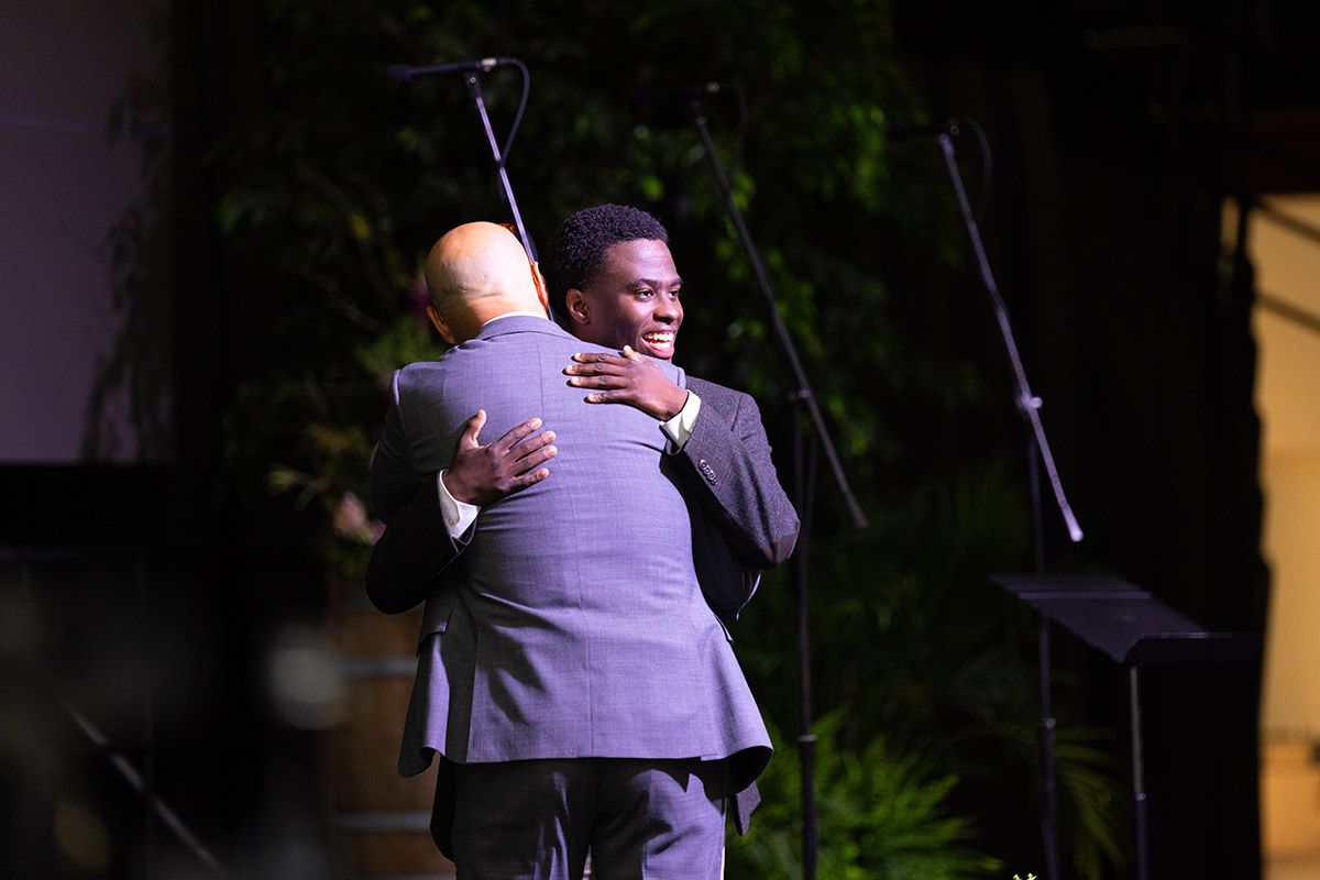 A student hugging a professor at the 250th celebration dinner at Hampden-Sydney College