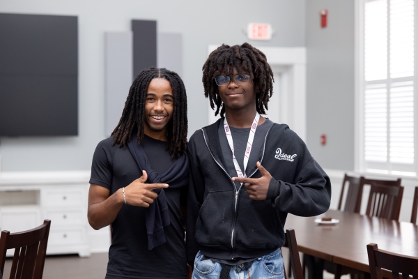 Two prospective students smiling at the camera