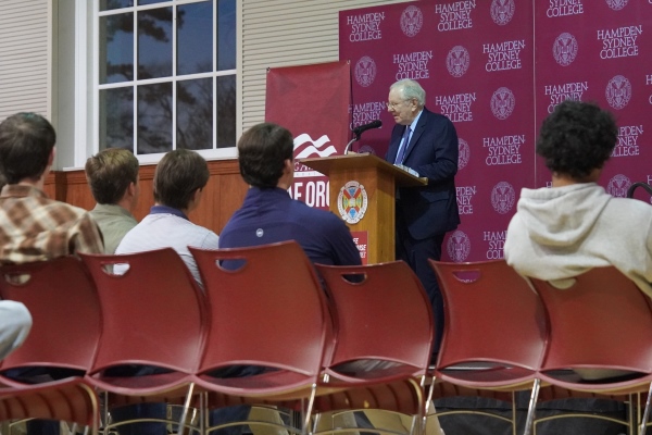 Steve Forbes standing at a lecturn giving a speech