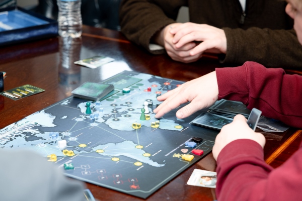 close-up view of a gameboard and hands playing a game