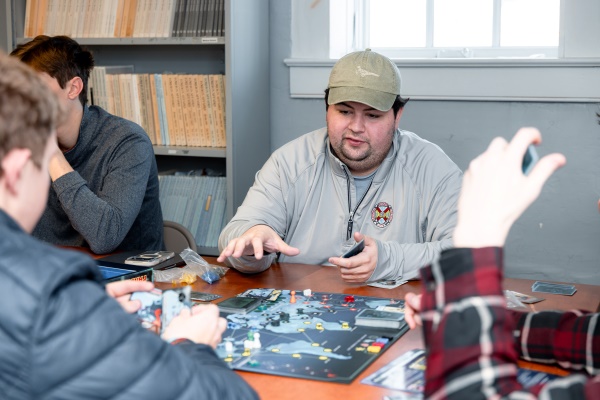 close-up view of students playing a strategic board game