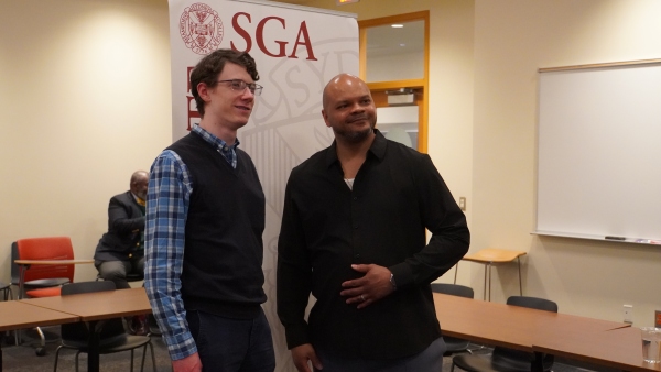 Kevin Richardson standing and talking with a student at a workshop