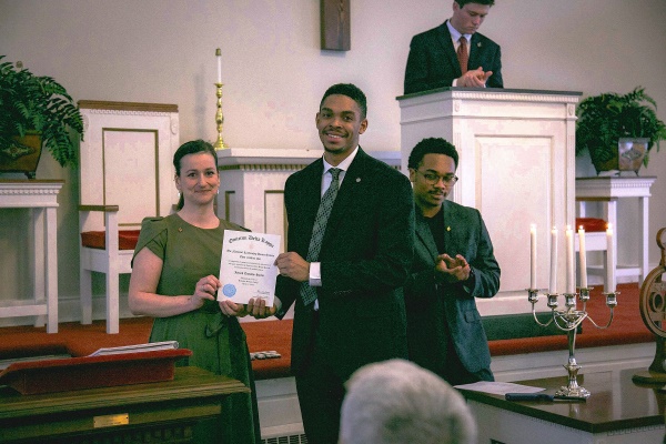 a student and Sue Carter accepting an award