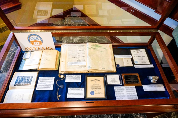 an exhibit display case containing ODK 100th anniversary documents