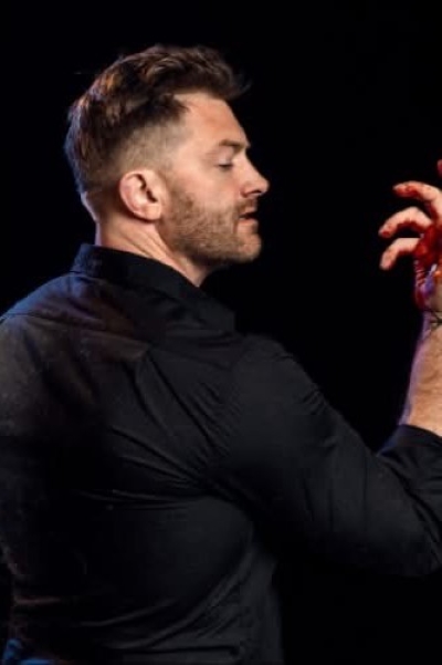 Actor Andrew Mitakides giving a dramatic expression 