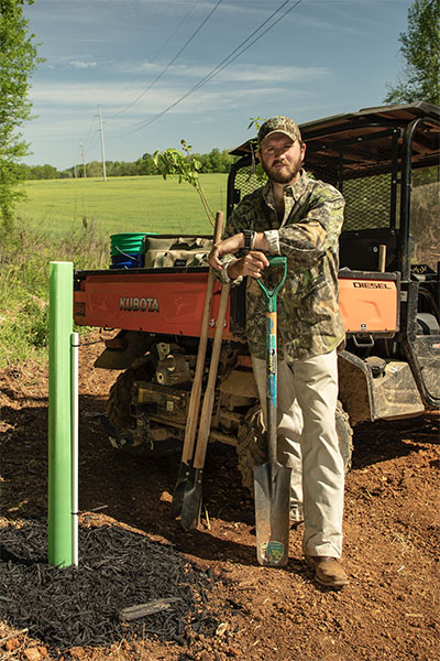 Haynes Shelton standing in a tree sapling stand