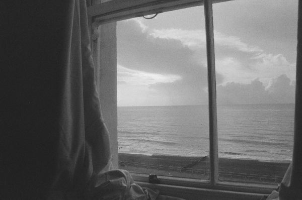 black and white view of the ocean outside a ship window