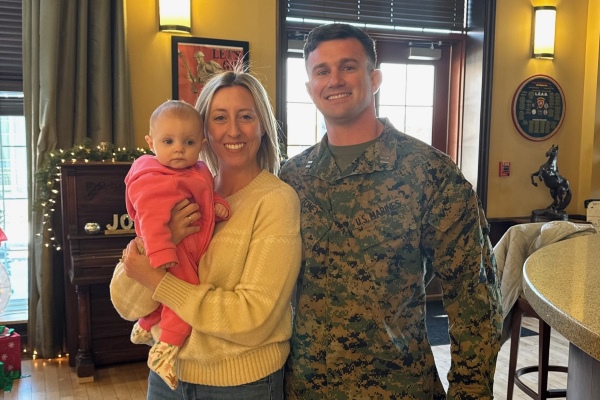 Zachary Toney in military fatigues with his family