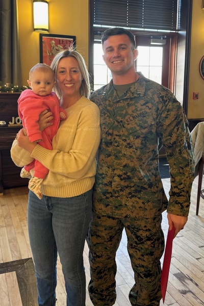 Zachary Toney in military fatigues with his family