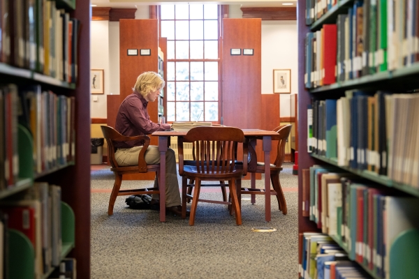 Bryson Smith doing research in the Bortz Library stacks