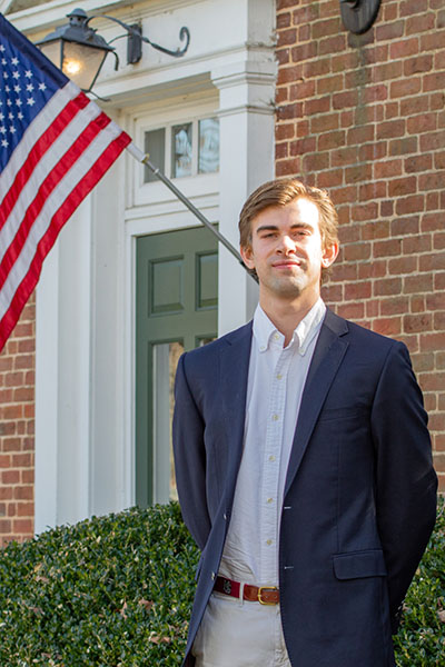 Andrew Parker standing beside a H-SC sign