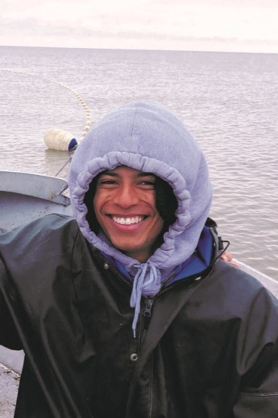 Izac Olatunji aboard a small boat 