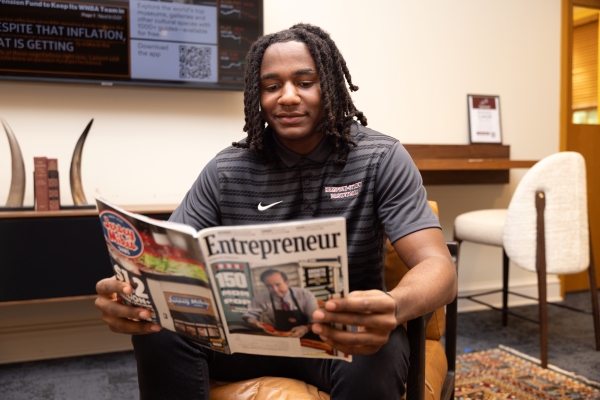 Asa Williams reading an entrepreneurship magazine