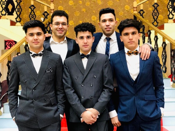 Kamal Iqbal standing with a group of friends