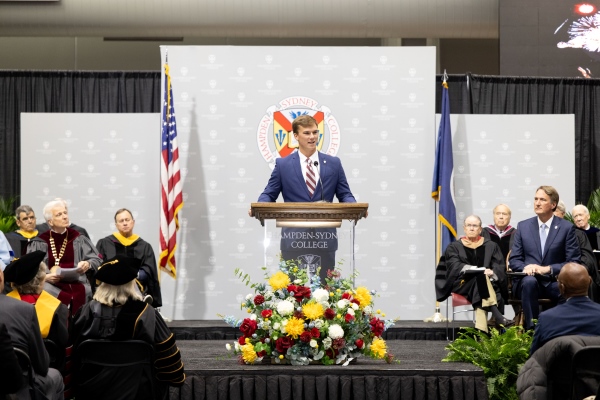 Owen Williams &rsquo;26 standing at a podium at the Founder's Daya convocation