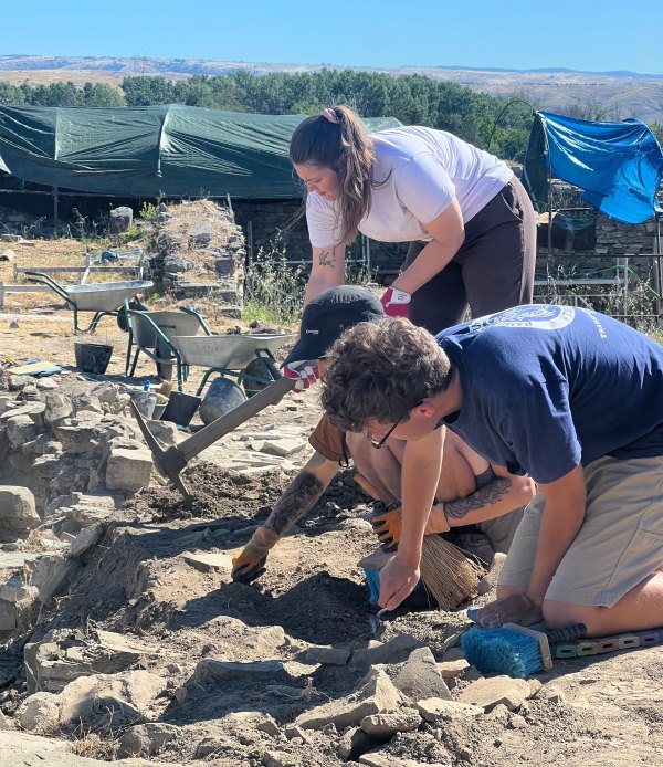 Dylan Evans digging in the dirt in an archaeology site