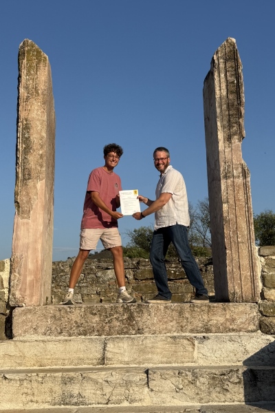 Dylan Evans and Matt Scheuller posing amidst ancient ruins
